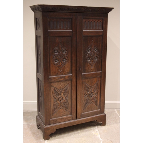 841 - A 17th century revival oak hall cupboard, late 19th/early 20th century, the carved cornice over a nu... 