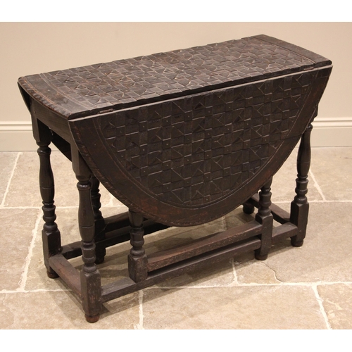 845 - A 19th century carved oak gateleg dining table, the chequer carved oval top upon baluster, bobbin an... 