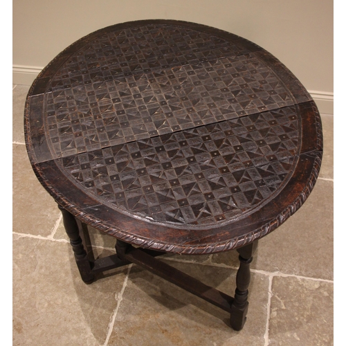 845 - A 19th century carved oak gateleg dining table, the chequer carved oval top upon baluster, bobbin an... 