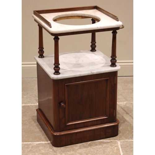 849 - A Victorian mahogany and marble wash stand, the white marble top with a three quarter gallery and ce... 