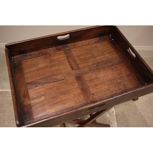 851 - A 19th century mahogany butlers tray, the hinged gallery tray upon an associated folding 'X' frame s... 