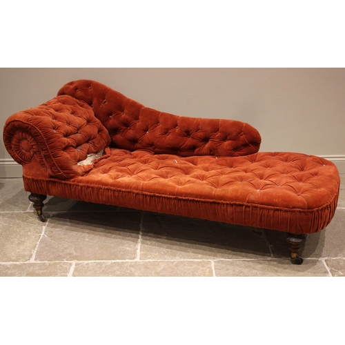 852 - A Victorian walnut and red velour chaise longue, with a button down scroll end and seat, upon beaded... 