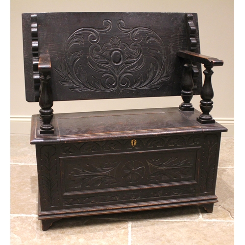 853 - A Victorian carved oak monks bench, in the 17th century style, the sliding back rest upon four balus... 