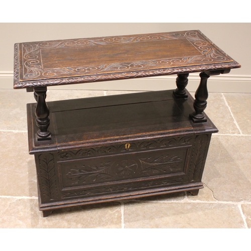 853 - A Victorian carved oak monks bench, in the 17th century style, the sliding back rest upon four balus... 