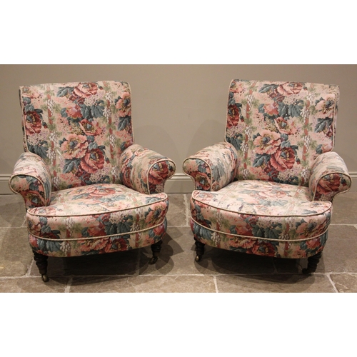 854 - A near pair of deep-seated armchairs, in the manner of Howard & Sons, late 19th/early 20th century, ... 