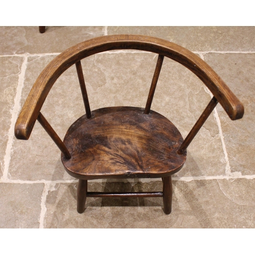 855 - A primitive elm and ash child's chair, 19th century, with a stick back, shaped and figured elm seat ... 