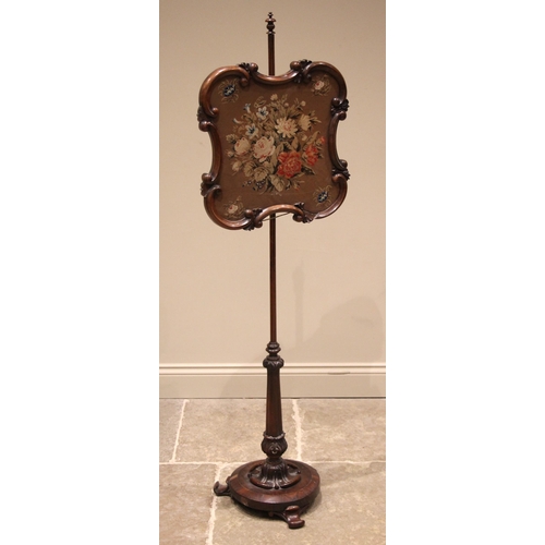 856 - A William IV rosewood pole screen, the glazed needlework screen within a scroll moulded frame, upon ... 