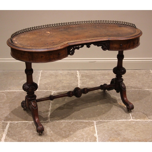 865 - A Victorian figured walnut kidney shaped writing desk, the skiver inset moulded top with a three qua... 