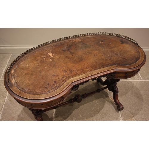 865 - A Victorian figured walnut kidney shaped writing desk, the skiver inset moulded top with a three qua... 