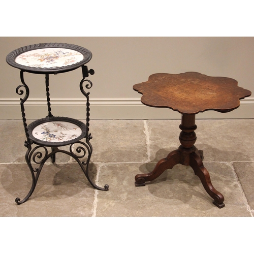 869 - A 19th century oak tripod table, the scalloped circular top upon a baluster column and three shaped ... 