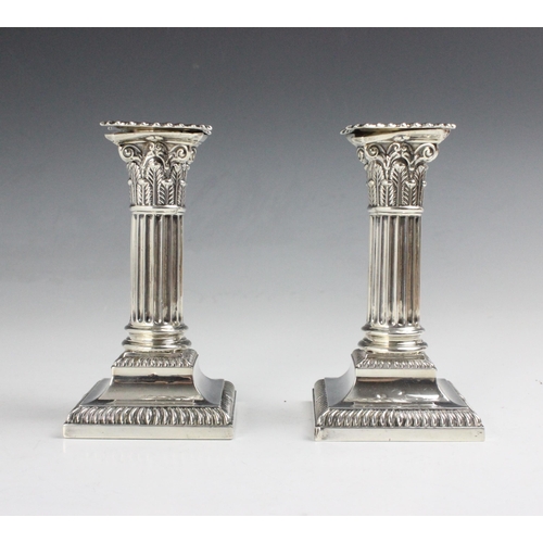 87 - A pair of Edwardian silver candlesticks, Hawksworth, Eyre & Co Ltd, Sheffield 1904, the removeable d... 