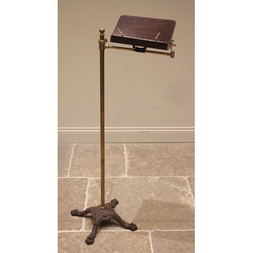 882 - A Victorian brass music stand, the mahogany sheet music holder with a single candle sconce, upon a b... 