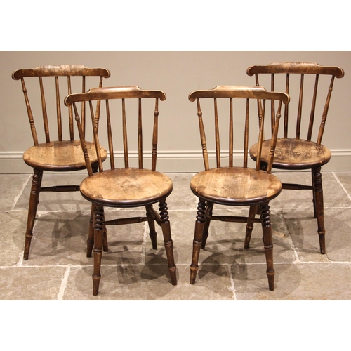 883 - A matched set of four Victorian beech wood kitchen chairs, each with a comb back over a circular sea... 