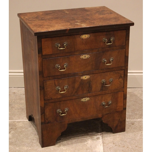 887 - A burr walnut bachelors chest of drawers, early 20th century, the book veneered top over an arrangem... 