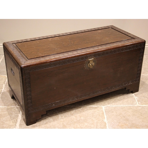 890 - A Chinese carved Camphor wood chest, mid 20th century, carved with peripheral Greek key pattern band... 