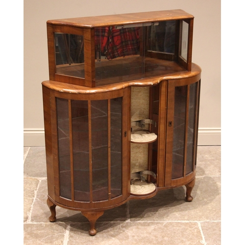 900 - A 1940's walnut cocktail cabinet, the upper section with glass sliding doors and mirrored back plate... 