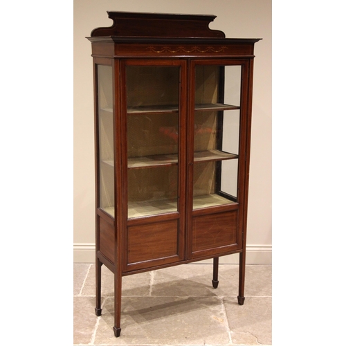 902 - An Edwardian mahogany display cabinet, the shaped rear pediment over a frieze inlaid with harebell s... 