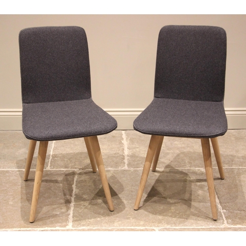 911 - A pair of Gazzda dining chairs, by Heals, the curved seat and back rest in grey felt fabric, upon li... 