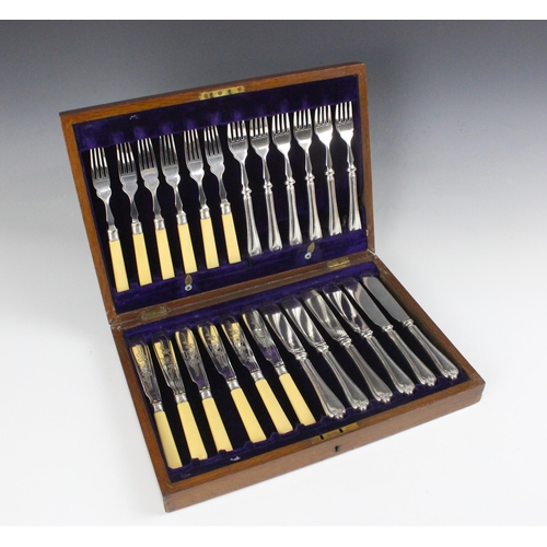 99 - A canteen of silver plated flatware, the six place fish service with knife blades engraved with foli... 