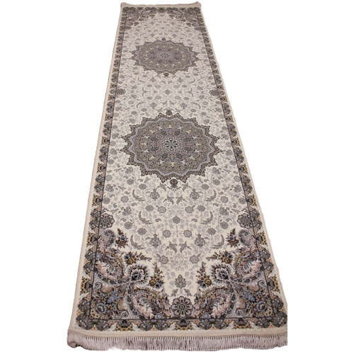 722 - A fine woven Iranian runner, the ivory ground centred with a pair of embossed floral medallions, enc... 