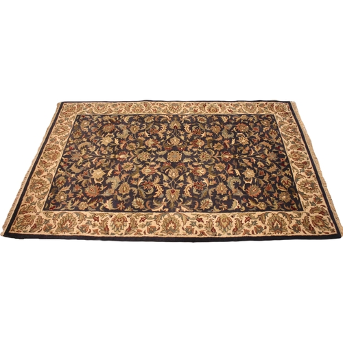 723 - A handmade Indian wool pile tea washed Jaipur rug, the all over floral design in autumnal shades upo... 