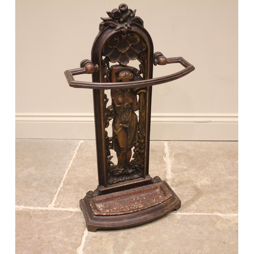 762 - A Victorian cast iron Greek revival stick stand, the bow front rail upon an arched openwork support ... 