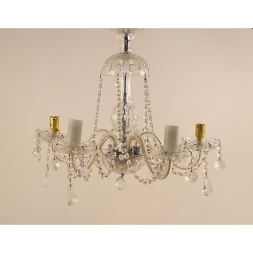 690 - A cut glass chandelier, 20th century, the domed top leading to five scrolling arms, suspending cut g... 