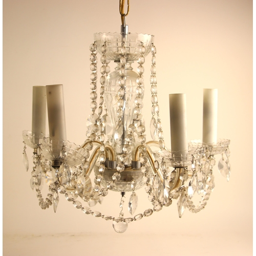 690 - A cut glass chandelier, 20th century, the domed top leading to five scrolling arms, suspending cut g... 