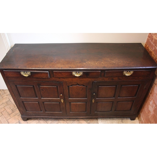 782 - An 18th century oak dresser base, the twin plank moulded top over three lip moulded frieze drawers a... 