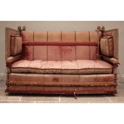 860 - An 18th century knoll or Knole sofa, in pink velour fabric applied with tassel fringes, the straight... 