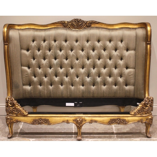 863 - A French Louis XV style giltwood bed, late 20th century, the padded button back head board within a ... 