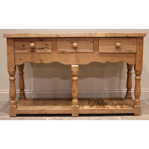 884 - A Victorian style pine dresser, late 20th century, the plate rack with a moulded cornice over a shap... 