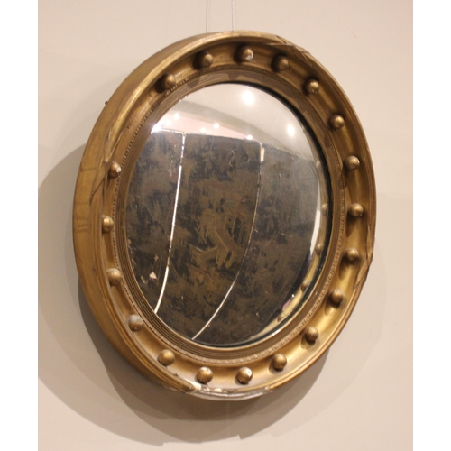 707 - A Regency style giltwood and gesso convex wall mirror, late 19th century, the moulded frame applied ... 