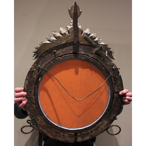 709 - A Regency girandole wall mirror, with a leafy fruit crest over the moulded circular frame applied wi... 