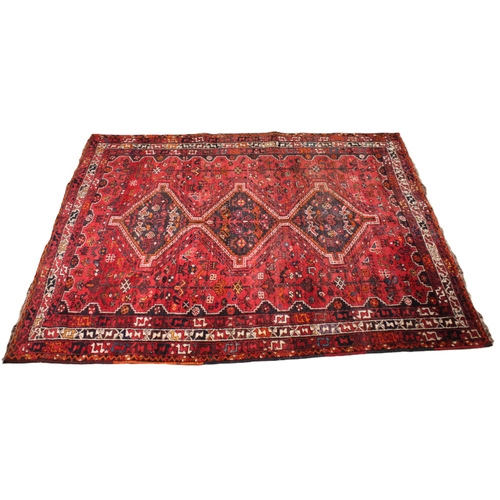 737 - An Iranian Shiraz rug, in red, brown, ivory and orange colourways, the all over foliate design punct... 