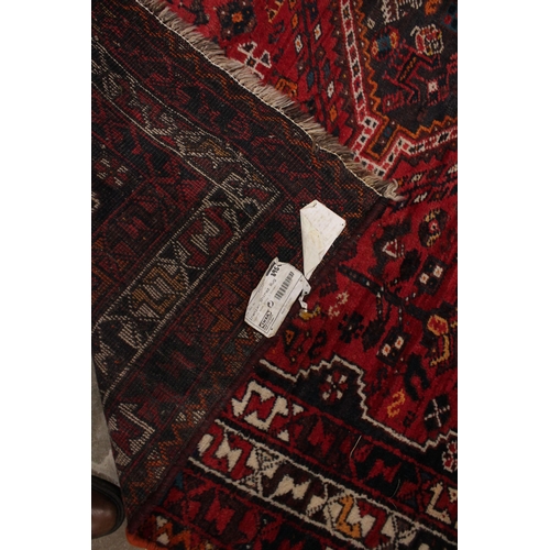 737 - An Iranian Shiraz rug, in red, brown, ivory and orange colourways, the all over foliate design punct... 