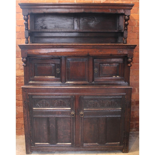 783 - A Welsh joined oak cwpwrdd tridarn, early 18th century, the upper tier with a panel back and shelf, ... 