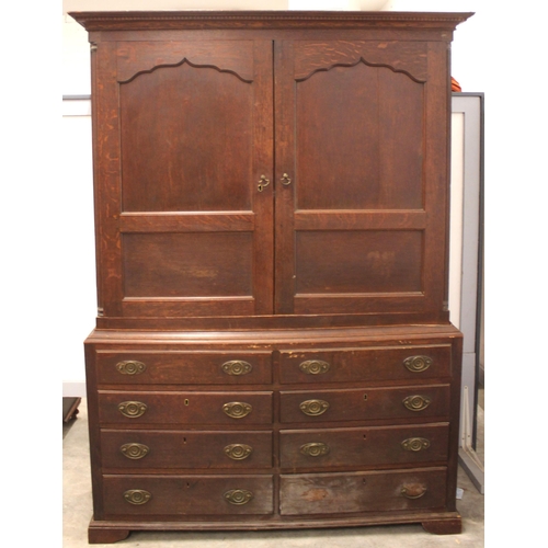 796 - A George III oak linen press, the moulded dentil cornice over a pair of ogee panelled cupboard doors... 