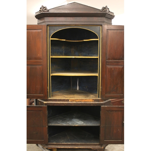 832 - A 19th century scumbled pine freestanding corner cupboard, the architectural cornice over a pair of ... 