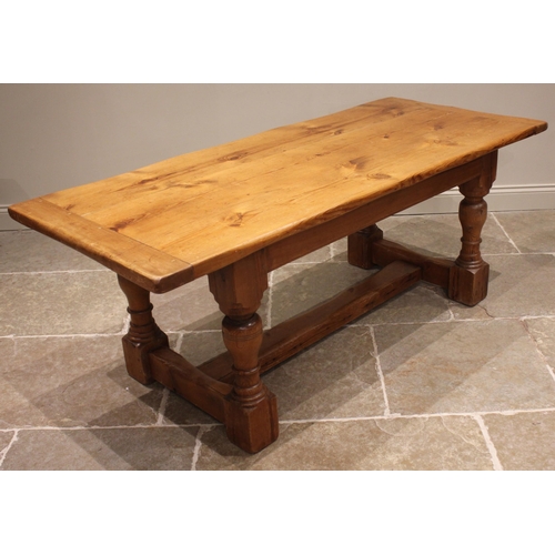 880 - A 19th century style pine refectory table, the cleated plank top upon ring turned baluster and block... 