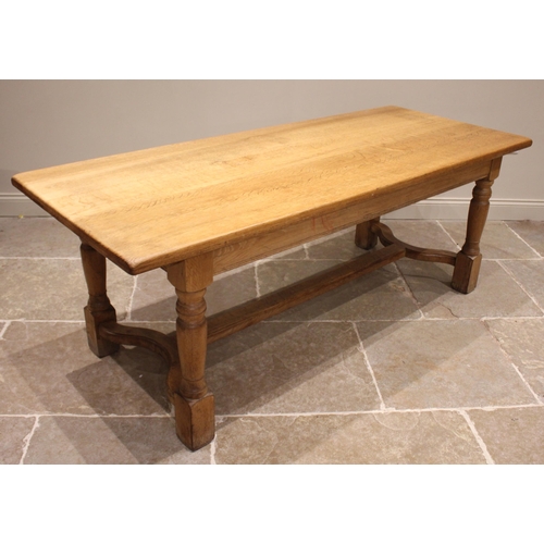 894 - A 17th century style light oak refectory table, 20th century, the slab top upon baluster supports an... 