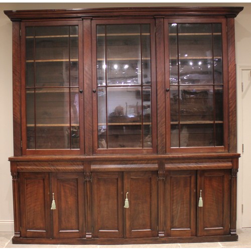 876 - A Victorian mahogany glazed library bookcase, of country house proportions, the moulded cornice over... 