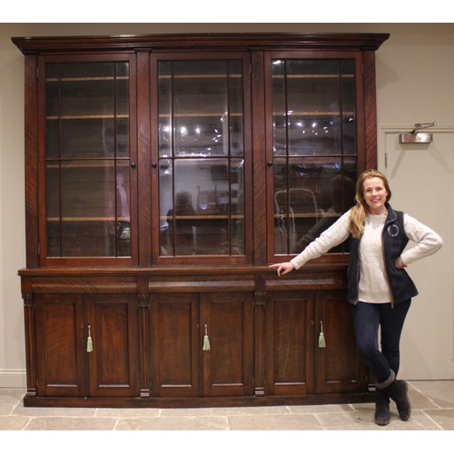 876 - A Victorian mahogany glazed library bookcase, of country house proportions, the moulded cornice over... 