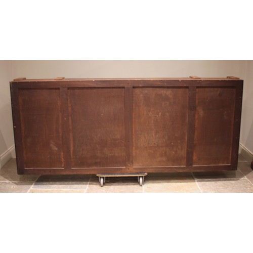 795 - A 19th century inverted breakfront mahogany bookcase, the nulled frieze with a central oval crest ov... 