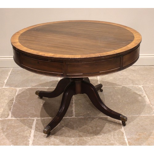 824 - An early 19th century mahogany drum library table, the crossbanded top above alternating real and fa... 