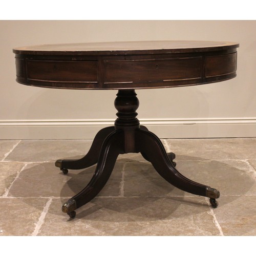 824 - An early 19th century mahogany drum library table, the crossbanded top above alternating real and fa... 