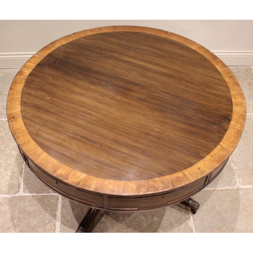 824 - An early 19th century mahogany drum library table, the crossbanded top above alternating real and fa... 