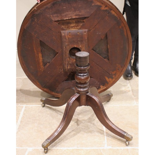 824 - An early 19th century mahogany drum library table, the crossbanded top above alternating real and fa... 