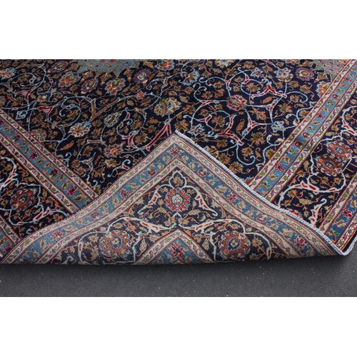 714 - A rich blue ground Persian Kashan carpet, the Shabazz lozenge medallion on a royal blue ground with ... 