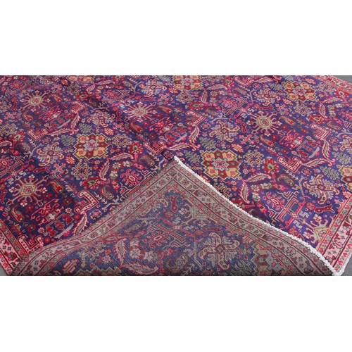 715 - A vintage blue ground Persian Tabriz carpet, with a traditional all over geometric design enclosed b... 